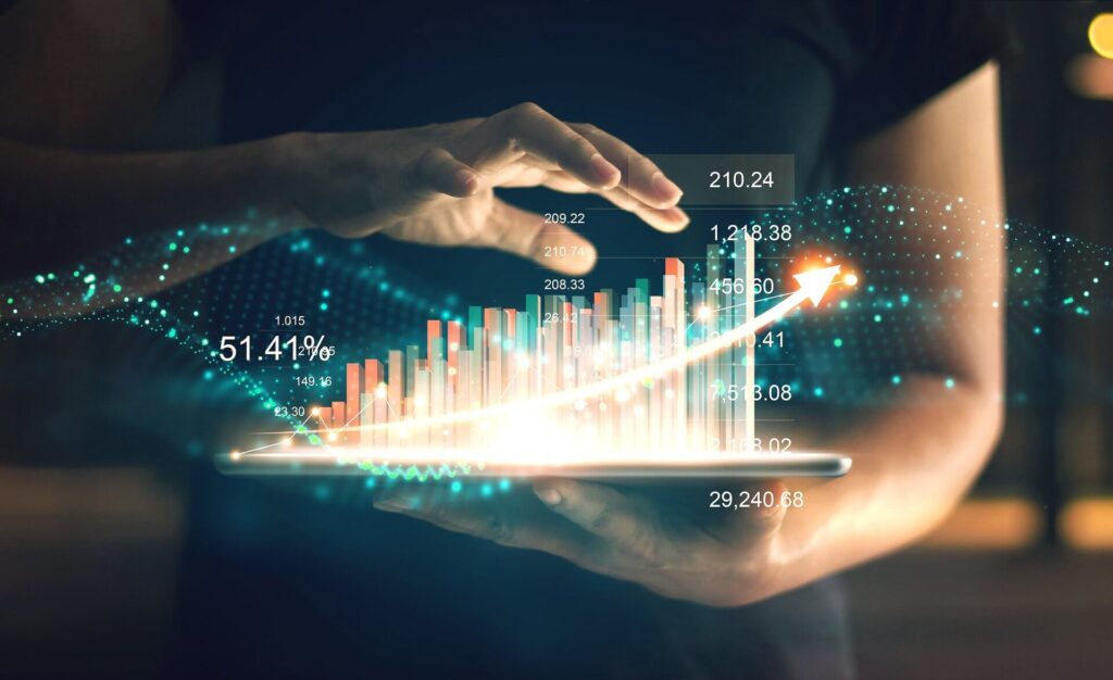 person holding tablet, with some stylized bar and line graphs coming out of the screen