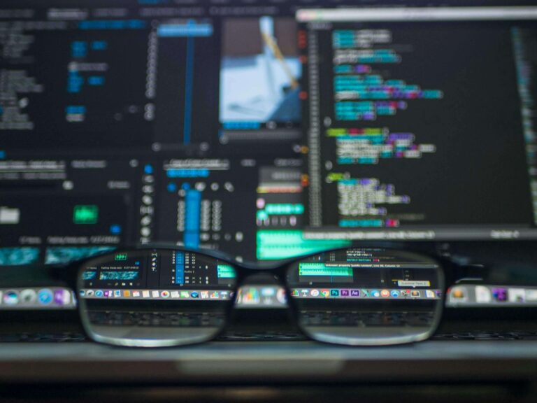 eye glasses on laptop, displaying a variety of web development tools/programs open